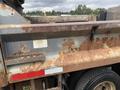 A rusted 2008 Mitsubishi Fuso FE180 truck bed with visible wear and peeling paint showcasing signs of aging and usage