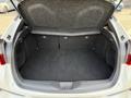 View of the open trunk of a 2021 Toyota C-HR featuring a spacious carpeted interior with a flat load floor and side compartments