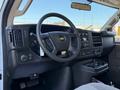 Interior view of a 2024 Chevrolet Express showcasing the dashboard steering wheel and controls with a focus on the layout and features