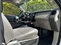 Interior view of a 2009 Ford F-550 featuring a gray driver's seat a central console and dashboard with vehicle controls and gauges