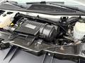 Engine compartment of a 2014 GMC Savana showing the air intake system and various components such as hoses and coolant reservoir