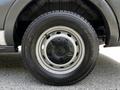 Close-up of a 2015 Ford Transit wheel featuring a silver steel rim and a black tire with visible tread pattern