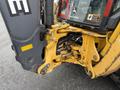 A 2011 John Deere 310SJ 4x4 Wheel Loader Extended Hoe 4 in 1 showcasing the hydraulic arm and bucket assembly in bright yellow and gray colors