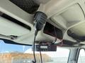 Interior view of a 2009 International 7500 featuring a mounted microphone and a radio unit attached to the overhead console