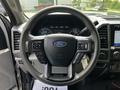 Steering wheel of a 2020 Ford F-350 Super Duty featuring multi-function controls and the Ford logo in the center