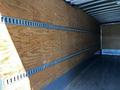Interior of a 2021 Hino 338 truck showing wooden walls with metal slats running horizontally and a wooden floor