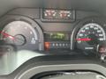 Dashboard of a 2009 Ford Econoline showing speedometer and fuel gauge with odometer reading 134312 miles and a temperature display reading 106 degrees