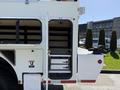 A 2008 International 7500 truck with an open side compartment featuring shelves and a small door next to it