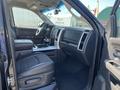 Interior of a 2011 RAM 1500 showing the front seats and dashboard with a modern design and various controls visible