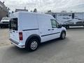 White 2010 Ford Transit Connect van parked in a lot showing side profile and rear view with no visible windows on the cargo area
