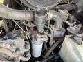 Close-up view of a Toro Groundmaster 5910 engine showing various components including hoses filters and metal parts