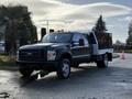 A 2008 Ford F-550 truck with a flatbed configuration has a black chassis and a metallic tool box mounted on one side