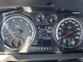 Dashboard of a 2011 RAM 1500 featuring speedometer tachometer fuel gauge and digital display for fuel economy and trip information