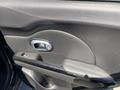 Interior door panel of a 2017 Kia Soul featuring a smooth black surface with a silver door handle and a black armrest