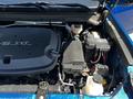 Close-up of the engine compartment of a 2021 Chevrolet Colorado showcasing the V6 engine and various components including the battery and coolant reservoir