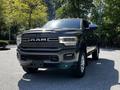 A 2022 RAM 3500 pickup truck is shown in the foreground with a prominent grille featuring the RAM logo and chrome accents, highlighted by a polished black exterior finish
