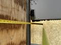 A measuring tape is extended from a marked point on the interior wall of a 2015 Freightliner M2 106 truck to indicate measurements