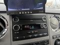 Dashboard of a 2011 Ford F-650 featuring a radio display with digital text and a screen showing a rearview camera image