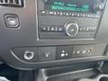 Interior control panel of a 2022 GMC Savana featuring radio controls and various buttons for settings and functions