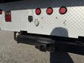 A 2017 International 4300 truck's rear with a hitch receiver and red and amber lights mounted on a diamond plate surface