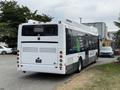 A 2018 Grande West Vicinity bus viewed from the rear with a white and green design showcasing its branding and features