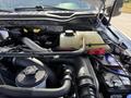 A close-up view of the engine compartment of a 2019 Ford F-550 showing various engine components and the battery with visible wiring and fluid reservoir