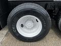 A close-up of a Michelin tire mounted on a 2017 International WorkStar 7600 featuring a white rim and tread pattern designed for heavy-duty performance