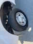 A 2016 Ford F-250 SD tire mounted on a silver rim with visible tread pattern and a shiny exterior