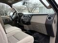 Interior view of a 2008 Ford F-350 showing beige seats dashboard and control panel with air conditioning and radio features