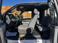 Side view of a 2011 Ford F-350 SD showcasing the front seats and dashboard with a grey interior