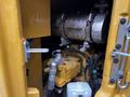 A close-up view of the engine compartment of a 2024 Caterpillar 306 showing the engine components and hoses