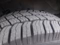 A close-up of a tire tread on a 2016 Chevrolet Express showing detailed grooves and patterns on the rubber surface