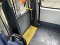 Interior view of a 2017 Chevrolet Express showing a wheelchair ramp in the lowered position with a textured metal surface and yellow support elements