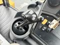 Close-up of the control lever of a 2011 John Deere 310SJ 4x4 Wheel Loader Extended Hoe 4 in 1 showing a black joystick and surrounding buttons
