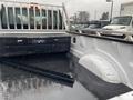 The image shows the bed of a 2017 Ford F-250 SD featuring a black tool box and a rubberized floor lining with visible water droplets