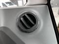 A close-up of an air vent control in the interior of a 2024 Caterpillar 306 machine