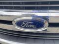 Front grille of a 2017 Ford F-550 featuring a large chrome emblem with the Ford logo in blue and silver