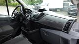 Interior view of a 2018 Ford Transit featuring a driver's seat steering wheel and dashboard with various controls and displays