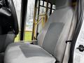 A gray and black driver's seat from a 2016 Ford Econoline with visible fabric details and seatbelt