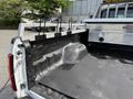 The image shows the bed of a 2011 Ford F-350 SD truck with a black lined interior and metal railing for securing cargo
