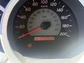 Dashboard of a 2010 Toyota Tacoma displaying a speedometer and an odometer reading 232930 km with a warning light illuminated