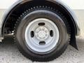 A close-up of a silver wheel with a five-bolt pattern and Bridgestone tire on a 2017 Chevrolet Express