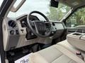 Interior of a 2008 Ford F-450 SD showing the dashboard steering wheel and seating with beige upholstery and controls on the dashboard