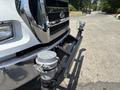 Front view of a 2015 Ford F-750 displaying its chrome grille and bumper with mounted equipment on the front frame