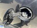 Close-up of the fuel filler cap of a 2011 RAM 1500 with the cap open revealing the fuel inlet and retaining clips