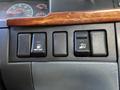 Three black control buttons on a dashboard with symbols for fuel, air suspension, and a warning indicator