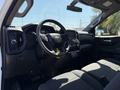 Interior view of a 2021 Chevrolet Silverado 1500 showcasing the steering wheel dashboard and front seats