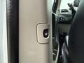 A close-up of the power window control button on the door of a 2017 Dodge Grand Caravan