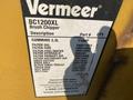 A close-up view of a yellow equipment label for a 2010 Vermeer Corporation BC1200XL brush chipper showing specifications and part information