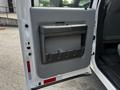 Interior door handle and panel of a 2016 Ford F-550 with a gray finish and storage compartment